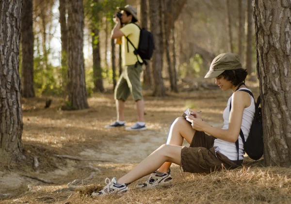 Cute young couple taking a break on a hiking trip