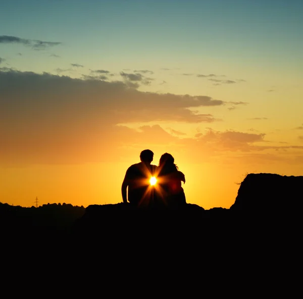 Couple holding each other during a sunrise