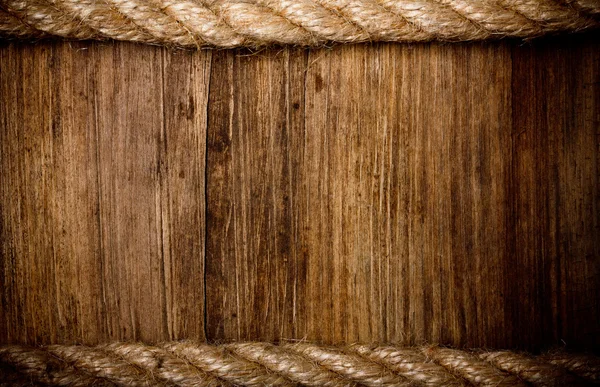 Rope on weathered wood background
