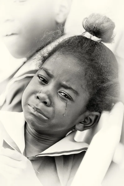 A portrait of a crying Ghanaian girl