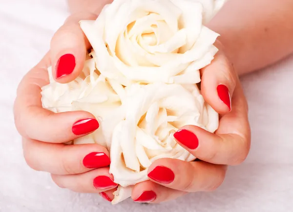 Closeup image of red manicure with flowers