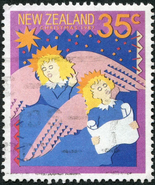 NEW ZEALAND - CIRCA 1987: A stamp printed in New Zealand, is dedicated to Christmas, is shown singing carols: Hark! The Herald Angels Sing, circa 1987