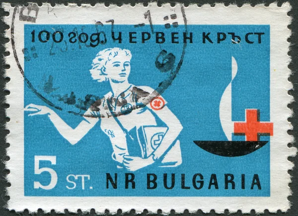 BULGARIA - CIRCA 1964: A stamp printed in Bulgaria, dedicated to the 100th anniversary of the Red Cross, shows a nurse, circa 1964