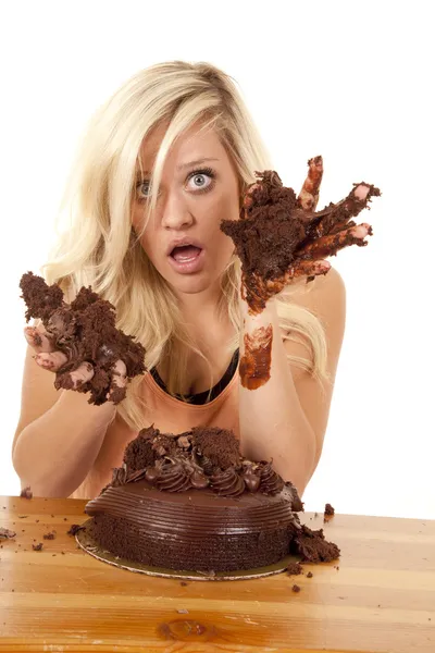 Woman with hands full of cake
