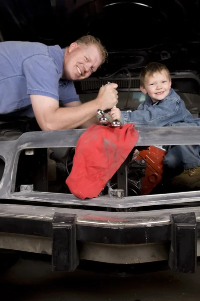 Father son working on car