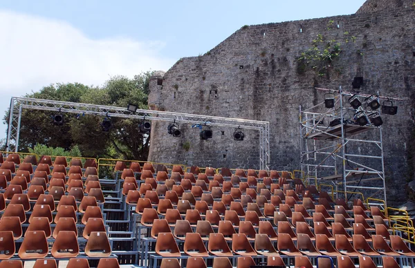 Empty seats in an open-air theater.