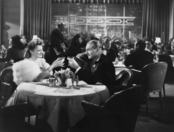 Couple dining in crowded restaurant