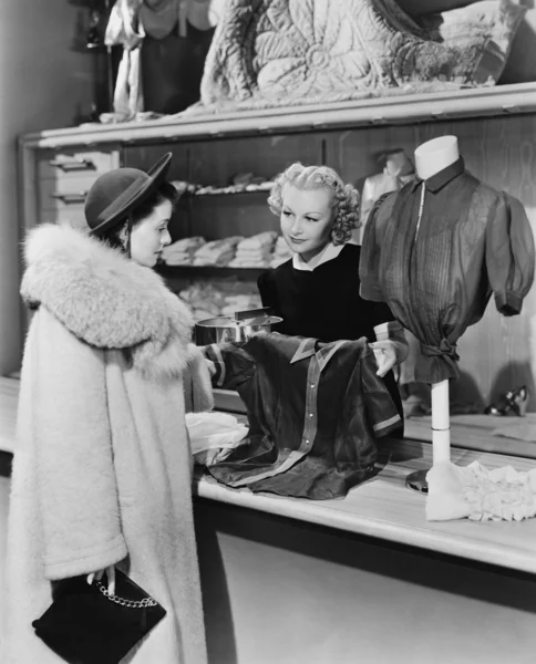 Customer and clerk in clothing store