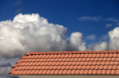 Roof tiles and blue sky with clouds clipart