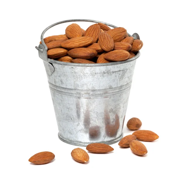 Tin bucket full of almonds — Stock Photo, Image