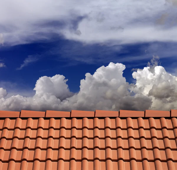 stock image Roof tiles and blue sky with clouds