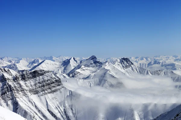 Snowy mountains in haze — Stock Photo, Image