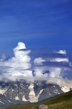 Summer mountains in clouds clipart