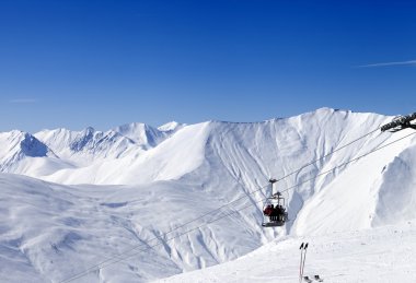 Skiers on ropeway at ski resort Gudauri clipart