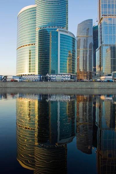 Skyscrapers at sunset and reflection — Stock Photo, Image