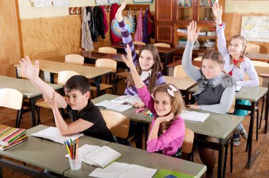 Schoolchildren raising hands
