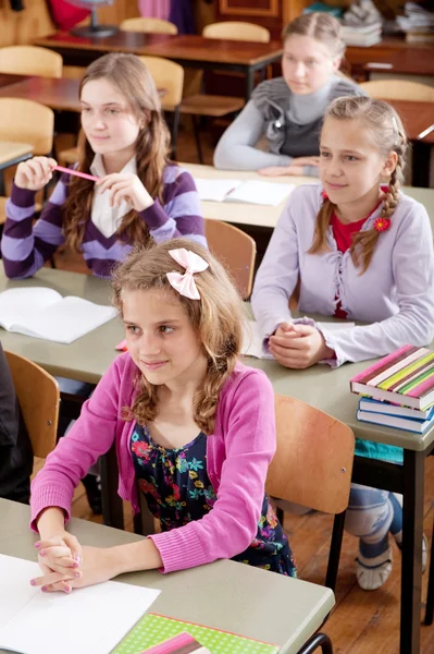 Schoolchildren at classroom during a lesson — Stock Photo, Image