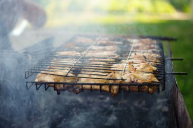 Smoke chicken in grates clipart