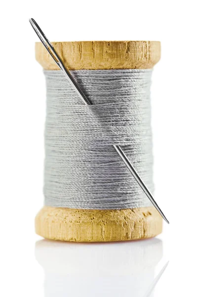 Spool with gray thread and nidle — Stock Photo, Image