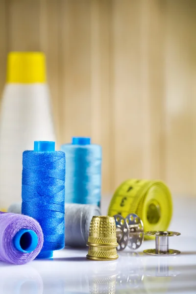 Composition of sewing items on a white wooden table — Stock Photo, Image