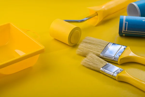 Painting tools on yellow table — Stock Photo, Image