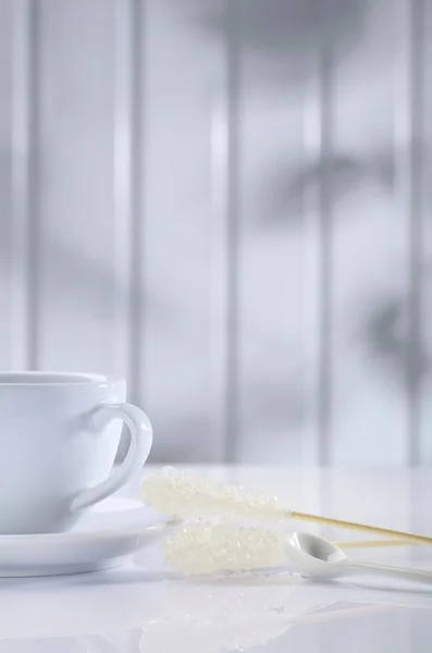 White ceramic cup and sugar stick — Stok fotoğraf
