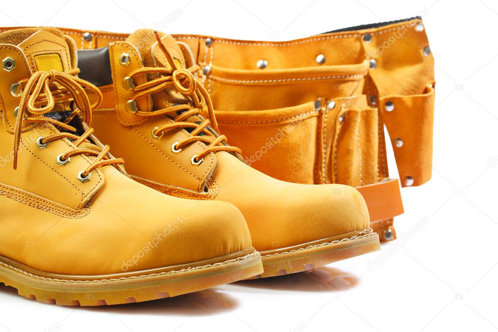 Pair of working boots and tool belt isolated