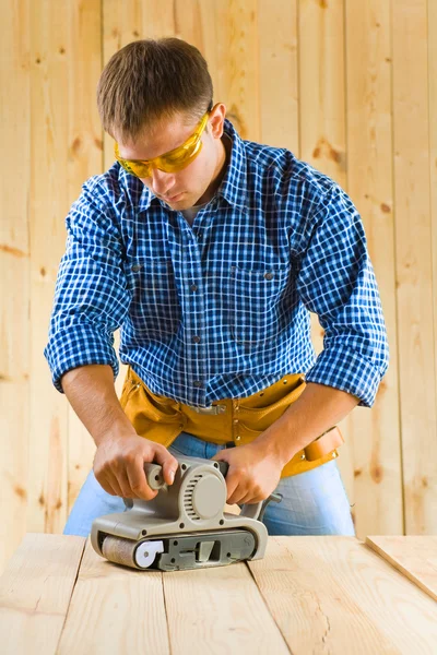 Young men works with detail sander Stock Photo