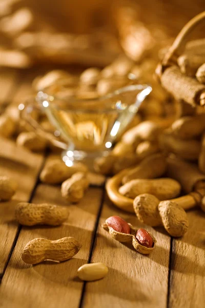Peanuts on wooden table — Stock Photo, Image