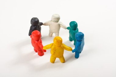 Human figures from clay stand in a circle clipart