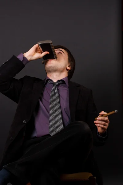 Young businessman smoking a cigar — Stock Photo, Image