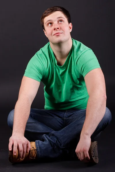 A young man sitting on the floor Stock Photo