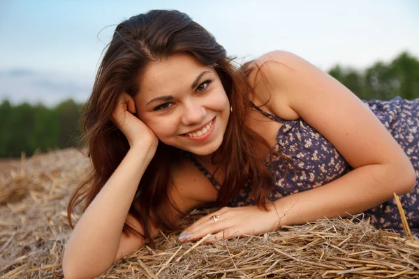Portrait of a beautiful girl on hay — Stock Photo, Image
