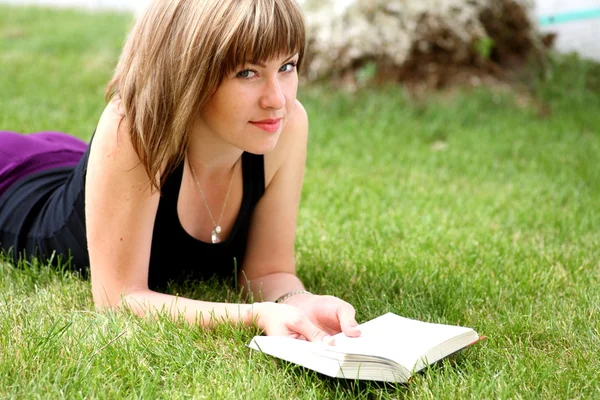 Young beautiful girl reading in the park Stock Photo