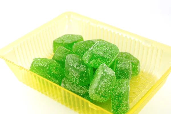 stock image Green fruit jelly in yellow case over white