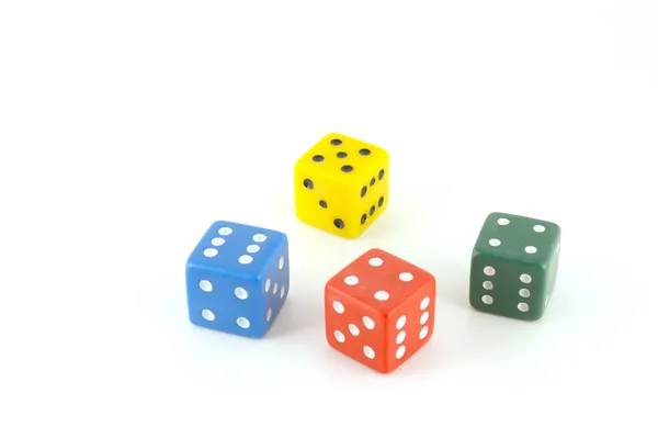 stock image Four color dice over white