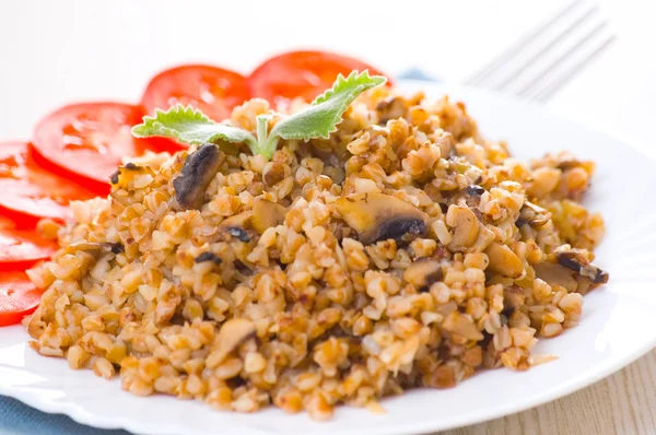 Stock image Buckwheat porridge with mushrooms on plate