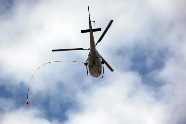 Reddingshelikopter beweegt in blauwe lucht met wolken — Stockfoto