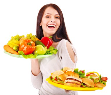 Woman choosing between fruit and hamburger. clipart