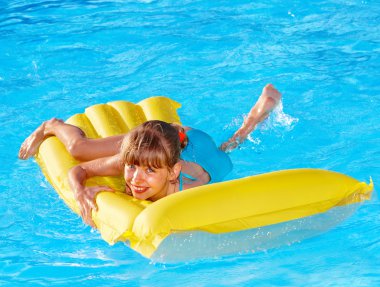Child swimming inflatable beach mattress. clipart