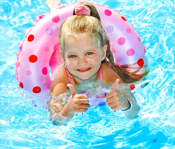 Child sitting on inflatable ring in swimming pool. — Stock Photo, Image