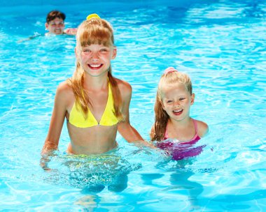 Children in swimming pool. clipart