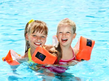 Children in swimming pool. clipart