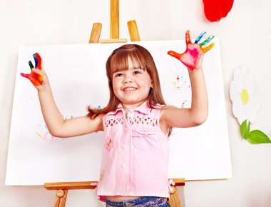 Child paint picture in preschool. clipart