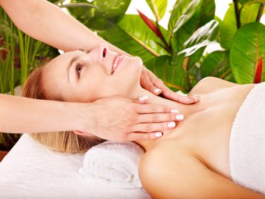 Woman getting facial massage . clipart