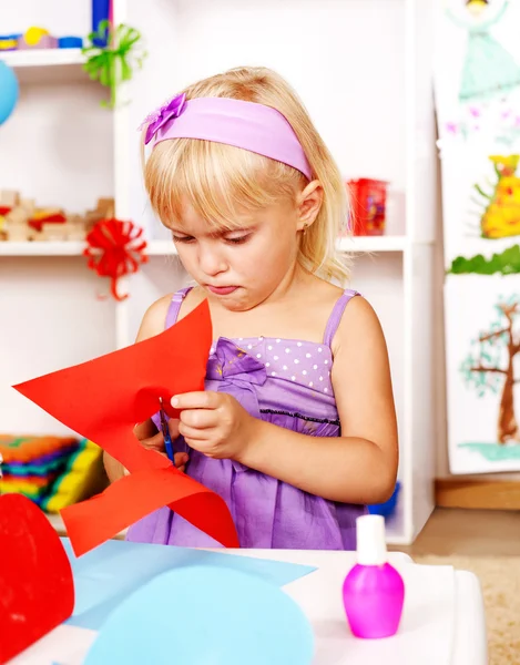 Criança recortando papel de tesoura no jardim de infância — Fotografia de Stock