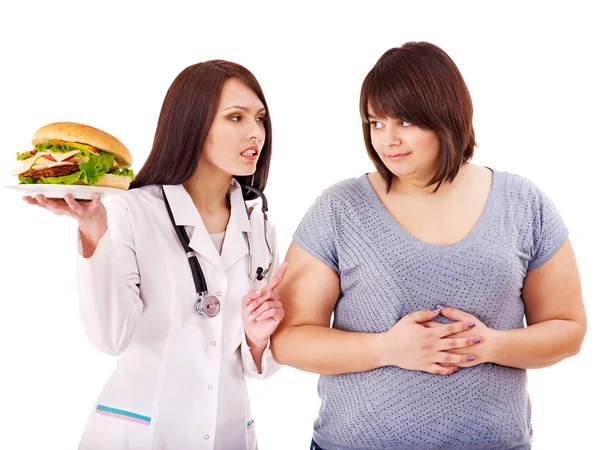 Vrouw met hamburger en arts. — Stockfoto