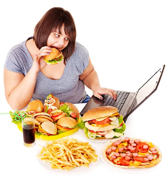 Woman eating junk food. — Stockfoto