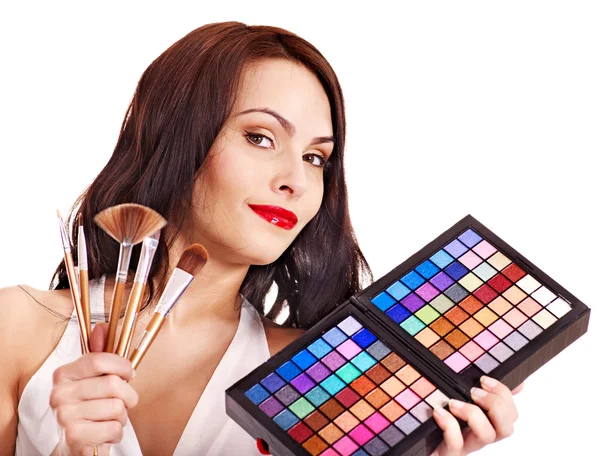 Girl holding eyeshadow and makeup brush. — Stock Photo, Image
