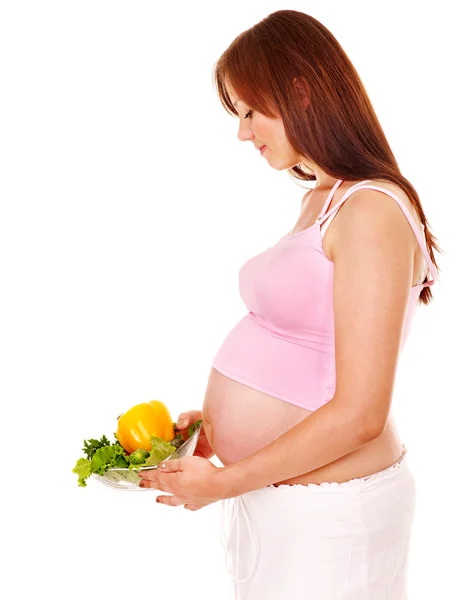 Těhotná žena jíst zeleniny. — Stock fotografie